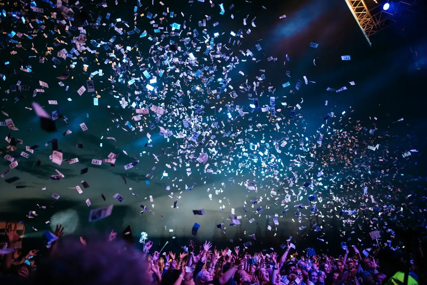 A crowded evening event with stage lighting