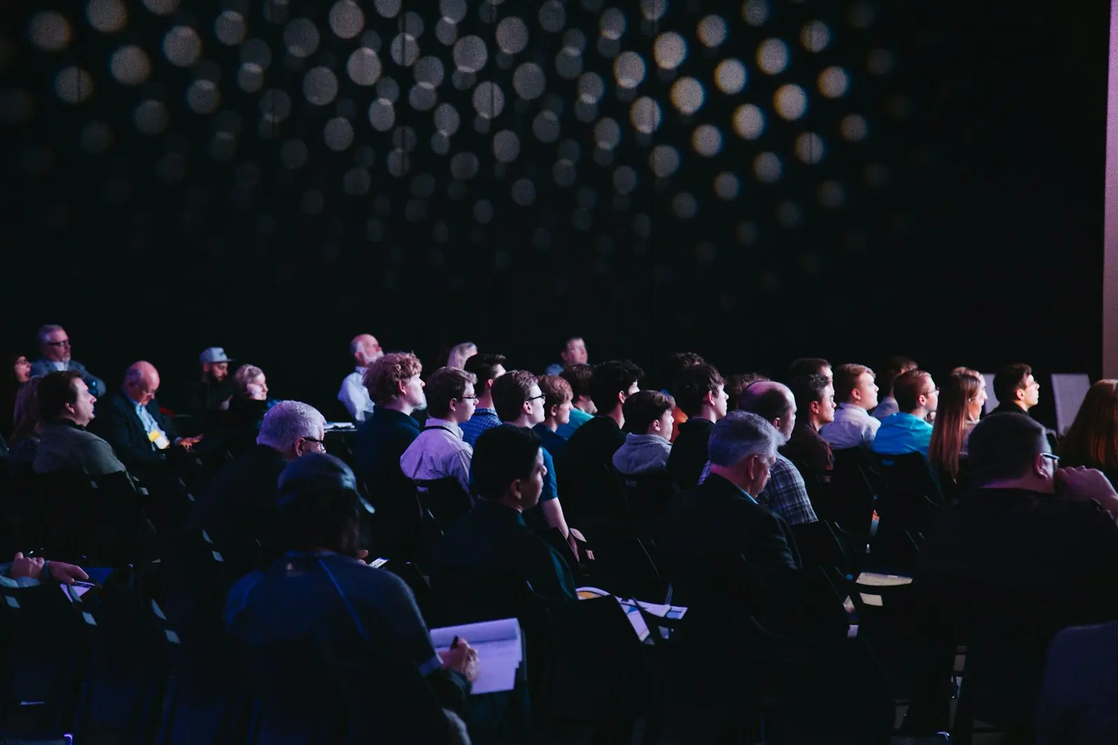 An audience seated in rows at an indoor gathering