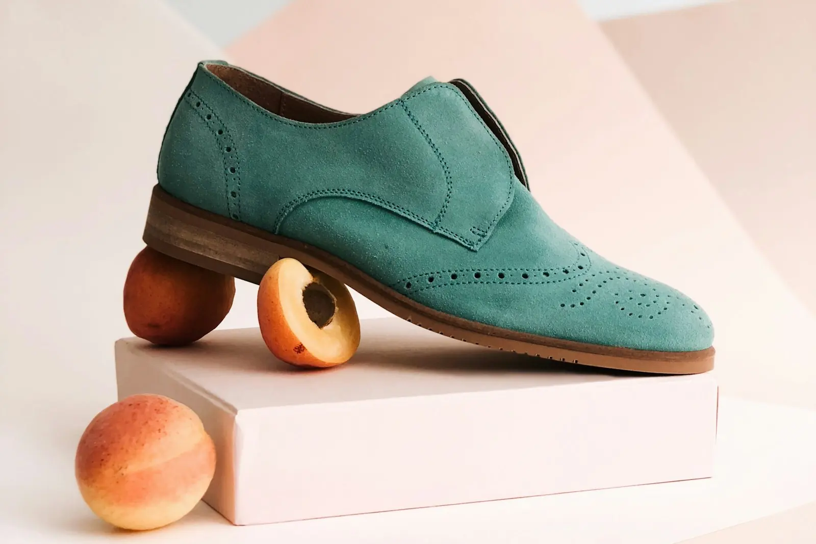 A shoe arranged on a plinth for a product photograph