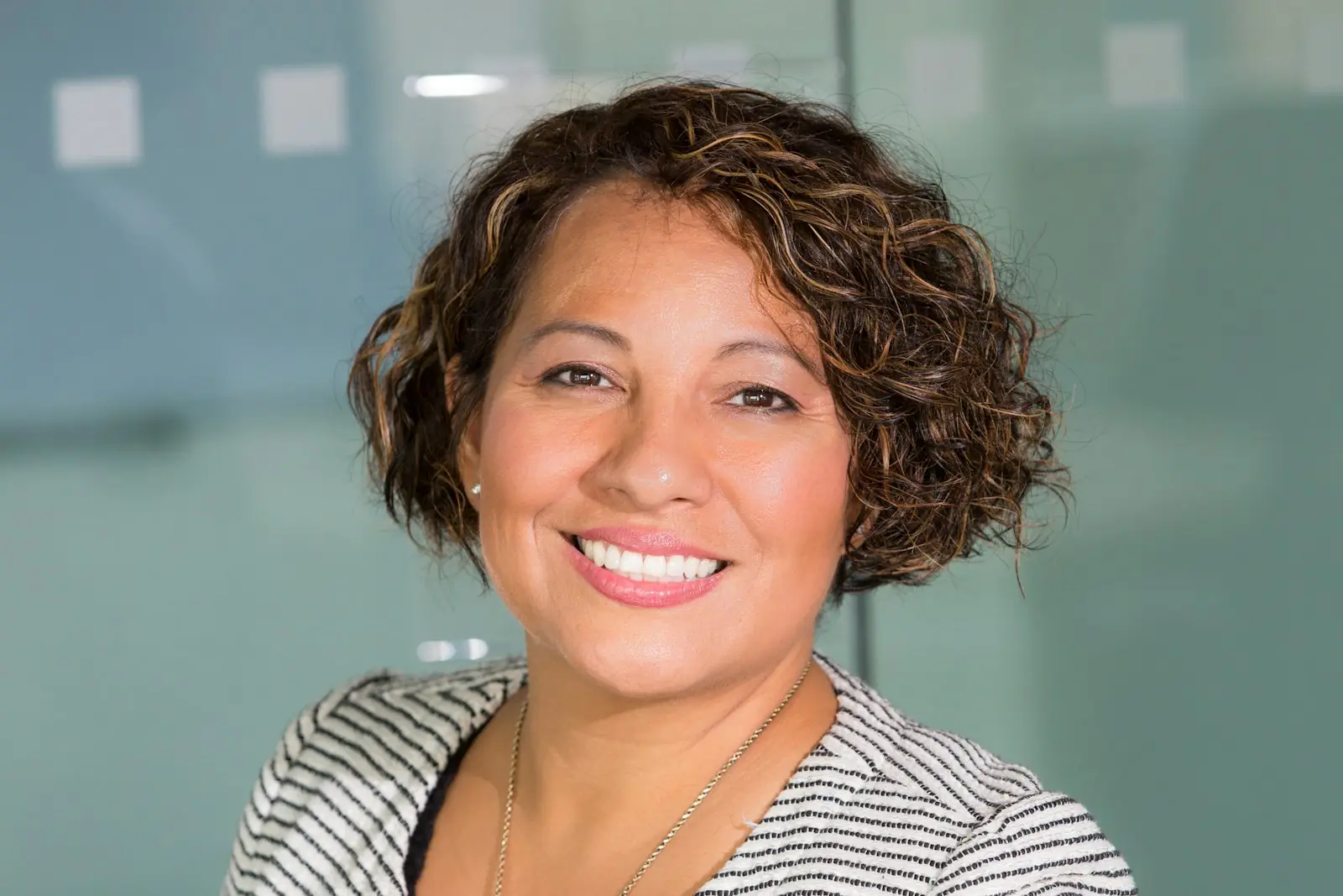 A professional woman photographed for a business headshot